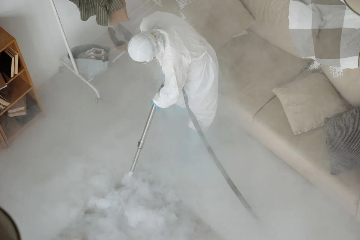 Biohazard cleanup technician in protective equipment, Hackberry, TX